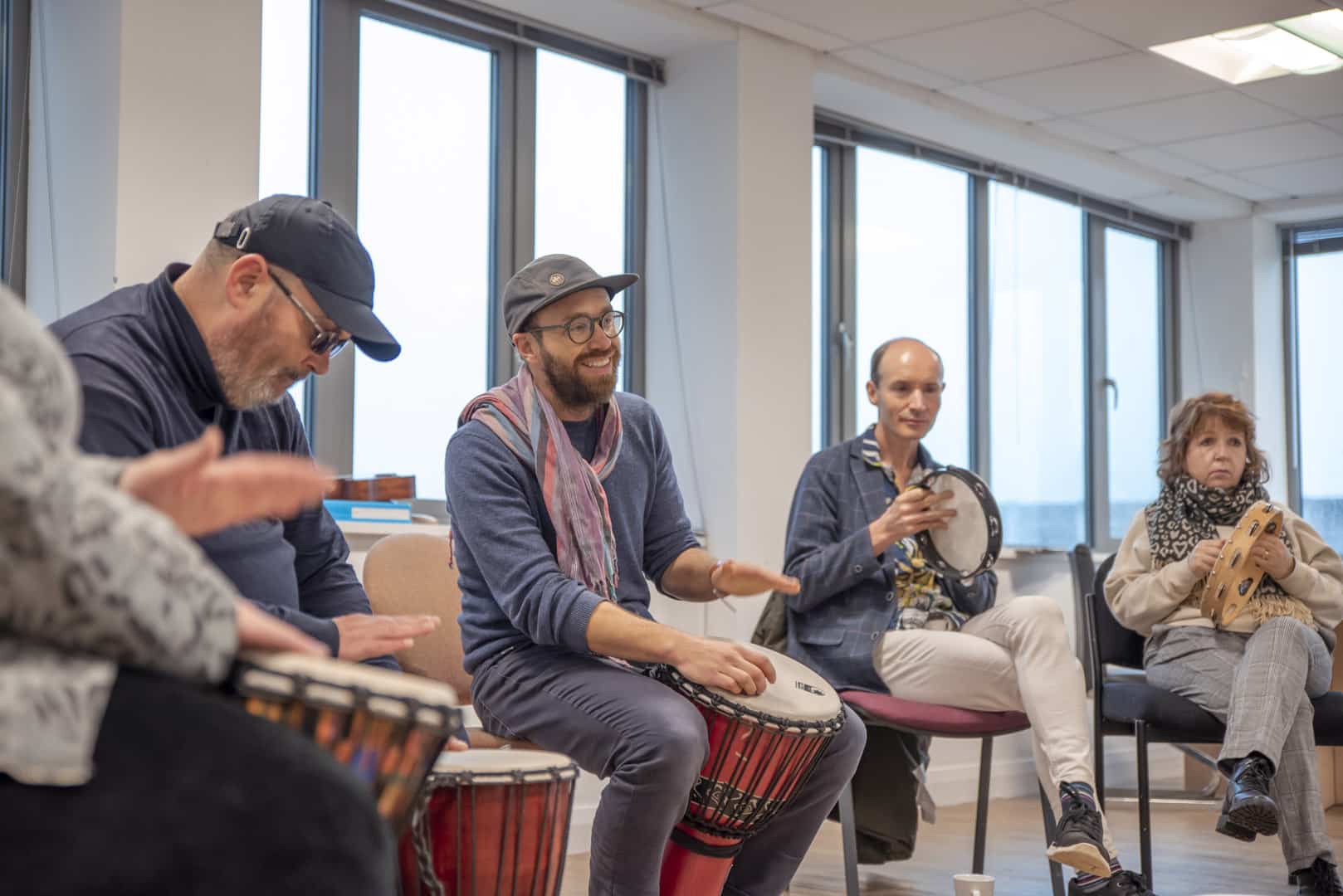 At partner organisation ReCoCo, music therapy takes place as people make music with drums and tambourines.