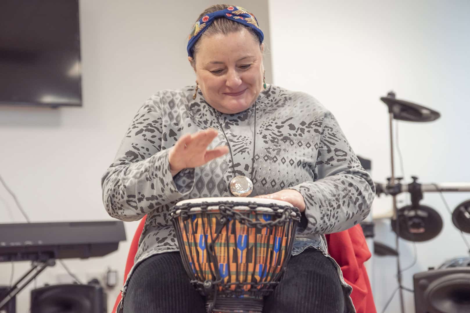 At one of partner organisations ReCoCo, someone happily plays the drum during a music therapy session.