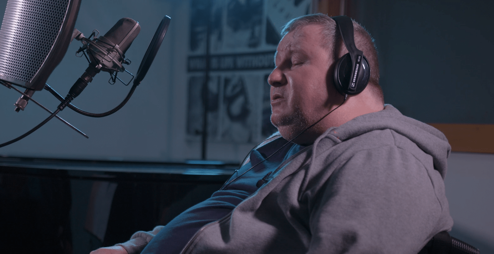 Music therapy client Tim has headphones on, as he professionally records both of his own songs at Shabbey Road Studio.