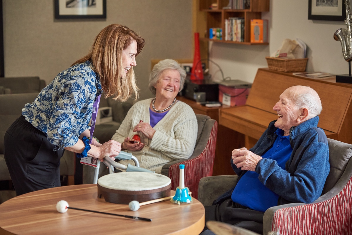 Three people chatting at a table