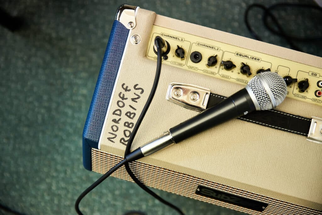 A microphone rests on top of an amplifier.