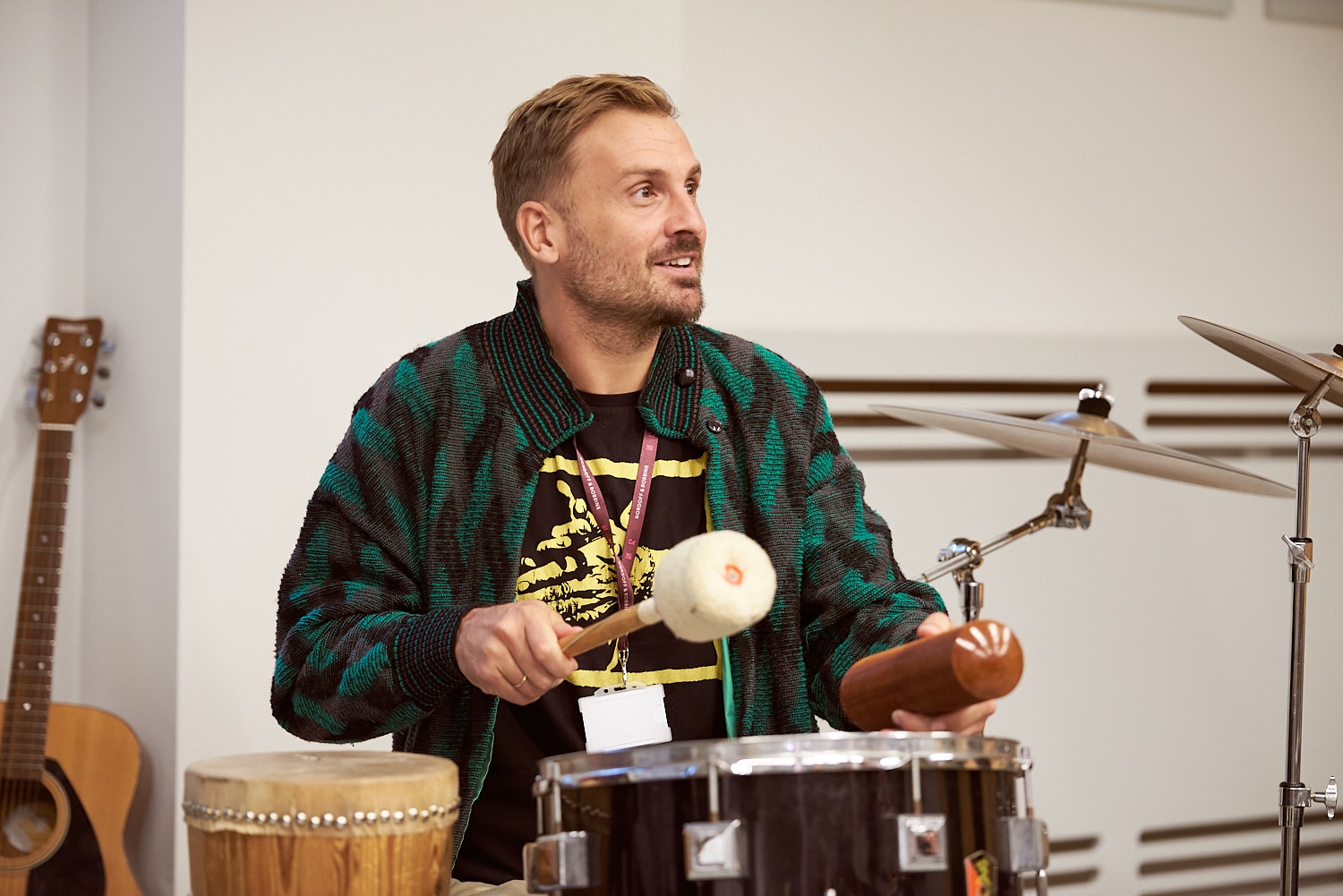 A Master of Music Therapy (MMT) student makes music on the drums at the Nordoff and Robbins London Centre.