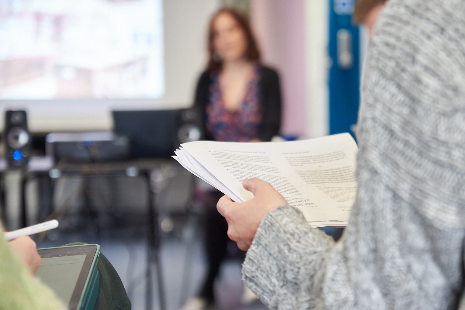 A Masters of Music Therapy Student (MMT) student reads a paper during a class