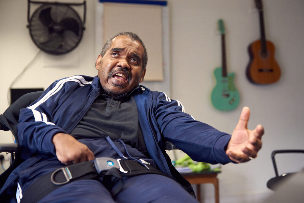 Erol sings passionately during a music therapy session with Oli