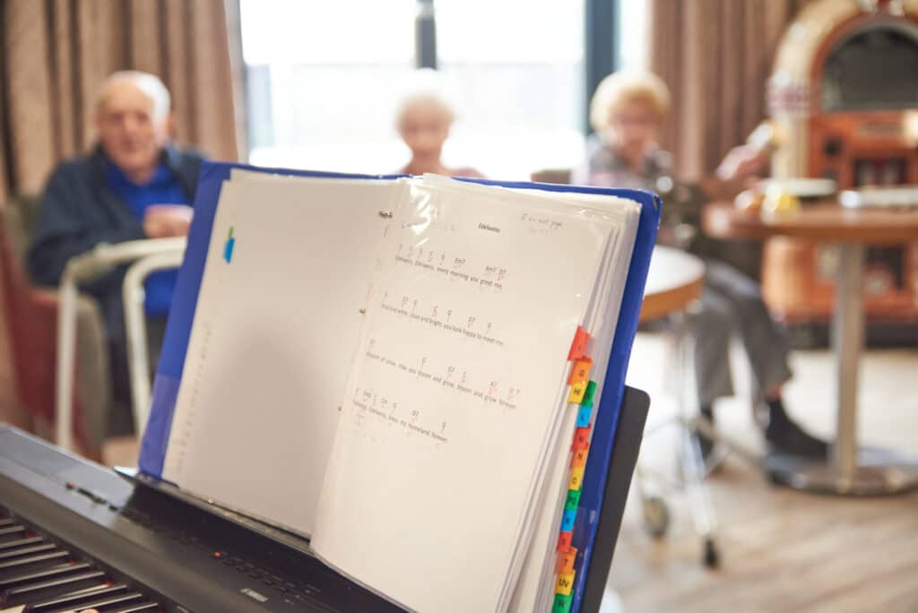 A music book sits open during a music therapy session.