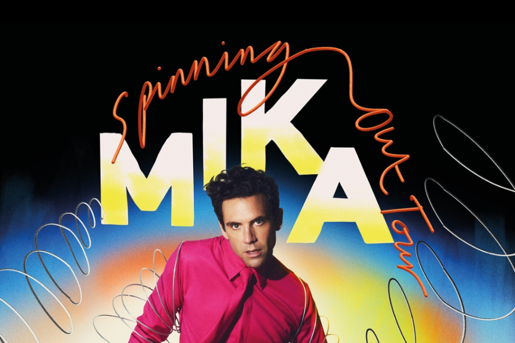 Mika is wearing a pink shirt in his 'Spinning Out' tour poster
