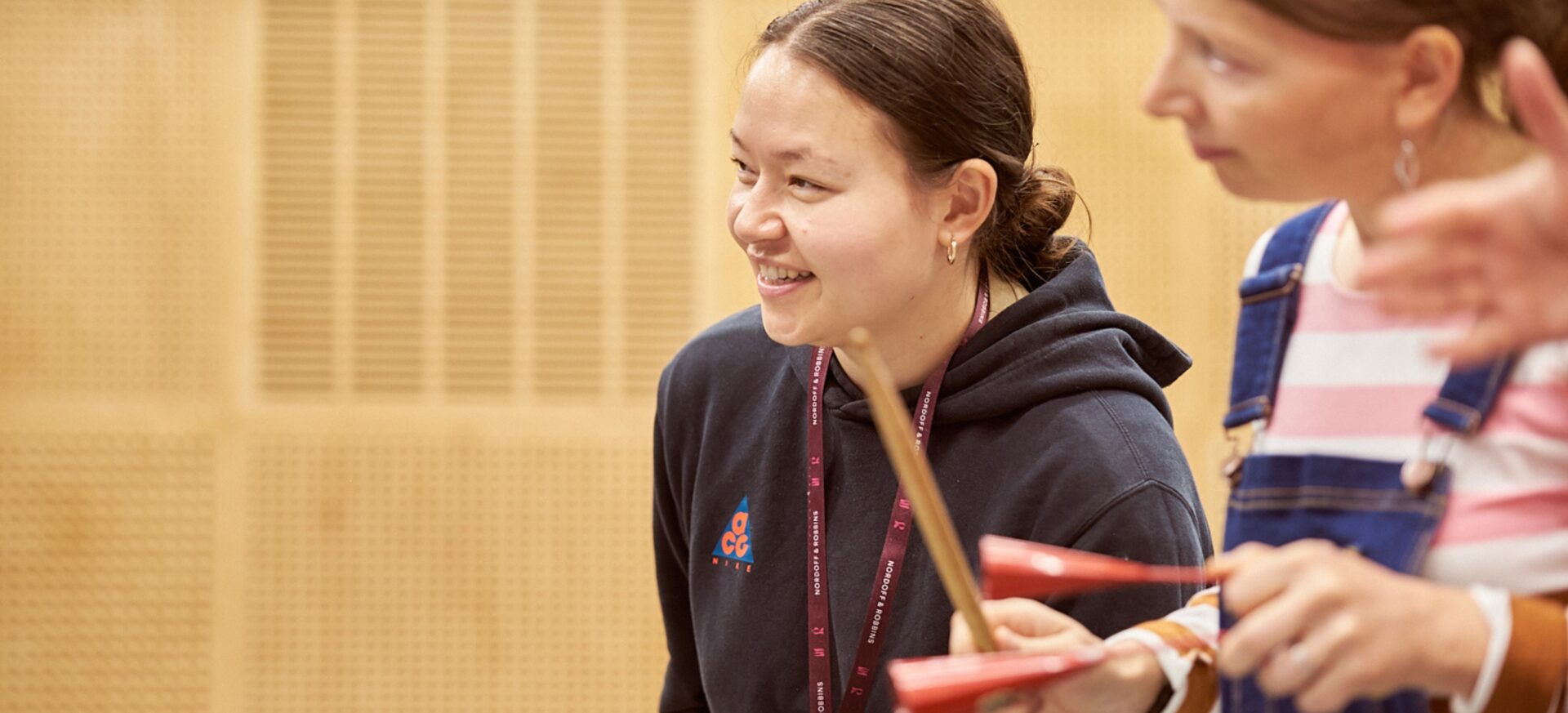 Two students playing percussion instruments