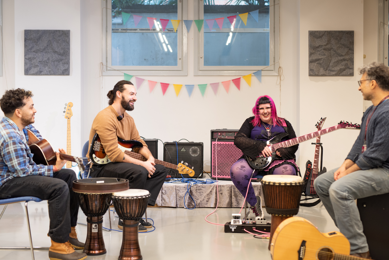 Brian Macdonald (PVRIS) and Ross Macdonald (The 1975) take part in a music therapy session with client Ruby and music therapist Jered, at the Nordoff and Robbins London Centre 