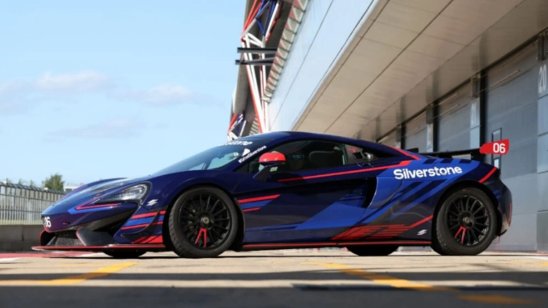 A blue McLaren race car with red and blue detailing